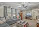 Inviting living room with a comfortable sectional sofa, a ceiling fan, and a dedicated workspace at 202 Oak Cir, Walterboro, SC 29488