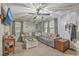 Comfortable living room with a large sectional sofa, modern ceiling fan, and plenty of natural light at 202 Oak Cir, Walterboro, SC 29488