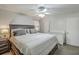 Spacious primary bedroom with a ceiling fan, large bed, nightstands, and an adjacent crib at 202 Oak Cir, Walterboro, SC 29488