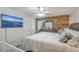 This main bedroom boasts a ceiling fan, television, wood accent wall, and ample space at 202 Oak Cir, Walterboro, SC 29488