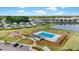 Areal view of a community pool, playground, and well-manicured lawns surrounded by neighborhood homes and trees at 204 Honey Horn Dr, Summerville, SC 29486