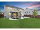 Spacious backyard with a patio, screened porch, and lush green lawn, perfect for outdoor enjoyment at 204 Honey Horn Dr, Summerville, SC 29486
