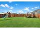 Backyard with a playset and trampoline, offering a recreational haven, enhanced by a well-kept lawn and secure fencing at 204 Honey Horn Dr, Summerville, SC 29486
