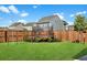 Expansive backyard featuring a trampoline set against a backdrop of lush greenery and a sturdy wooden fence for privacy at 204 Honey Horn Dr, Summerville, SC 29486