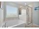 Bright bathroom with a soaking tub and glass enclosed shower at 204 Honey Horn Dr, Summerville, SC 29486