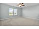 Bright bedroom featuring large windows, neutral carpet, and a ceiling fan at 204 Honey Horn Dr, Summerville, SC 29486