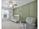 Comfortable Bedroom features a stylish accent wall and a white crib next to a glider at 204 Honey Horn Dr, Summerville, SC 29486