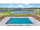Aerial view of a large community pool with lounge chairs and a nearby pond, great for recreation at 204 Honey Horn Dr, Summerville, SC 29486