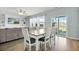 Sunlit dining area boasts hardwood floors, a modern table with seating, and sliding glass doors to the patio at 204 Honey Horn Dr, Summerville, SC 29486