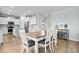 Well-lit dining area next to a modern kitchen with stainless steel appliances and white cabinetry at 204 Honey Horn Dr, Summerville, SC 29486