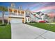 Lovely two-story home with balcony, an attached two-car garage, manicured lawn, and extended driveway at 204 Honey Horn Dr, Summerville, SC 29486