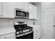 A well-equipped kitchen features stainless steel appliances and white cabinets at 204 Honey Horn Dr, Summerville, SC 29486