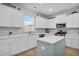 Kitchen featuring white cabinets, modern stainless steel appliances, and an island with a blue accent at 204 Honey Horn Dr, Summerville, SC 29486