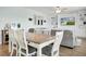 Open-concept living area with dining table, comfortable sectional sofa, and custom built-in shelving at 204 Honey Horn Dr, Summerville, SC 29486