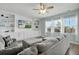 Comfortable living room featuring custom built-in shelving, a ceiling fan, and plenty of natural light at 204 Honey Horn Dr, Summerville, SC 29486