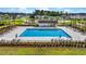 Aerial view of a community pool with lounge chairs and umbrellas, perfect for summer relaxation at 204 Honey Horn Dr, Summerville, SC 29486