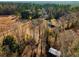 Aerial view of the house showcasing surrounding woodland and farmland at 2042 Highway 402, Moncks Corner, SC 29461