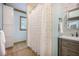 Bright bathroom features a shower with white tile and a vanity with drawers and a cabinet for storage at 2042 Highway 402, Moncks Corner, SC 29461