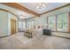 Spacious bedroom featuring wooden beam ceiling, neutral colors, a sitting area, and large windows at 2042 Highway 402, Moncks Corner, SC 29461