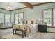 Relaxing bedroom with light green walls, natural wood beams, large windows, and neutral bedding at 2042 Highway 402, Moncks Corner, SC 29461