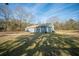 Exterior shot of the property showcasing its yard and simple architecture at 2042 Highway 402, Moncks Corner, SC 29461
