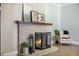 Close-up of a brick fireplace with decorative mantel, hearth accessories, and warm, inviting flames at 2042 Highway 402, Moncks Corner, SC 29461