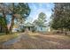 Charming single-story home with brick accents, green siding, and a welcoming front porch at 2042 Highway 402, Moncks Corner, SC 29461