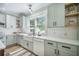 This updated kitchen features light green cabinets, stainless appliances and a large window at 2042 Highway 402, Moncks Corner, SC 29461