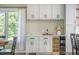 A kitchen wet bar with wine storage, light green cabinetry, a stone countertop, and ample storage space at 2042 Highway 402, Moncks Corner, SC 29461