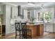 Beautiful open kitchen with stainless appliances, island, barstool seating, and wooden floors at 2042 Highway 402, Moncks Corner, SC 29461