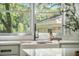 Farmhouse kitchen sink with modern faucet and bright natural light from a window with green view at 2042 Highway 402, Moncks Corner, SC 29461