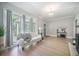 Bright living room with large windows, comfortable seating, and a view of the outdoor landscape at 2042 Highway 402, Moncks Corner, SC 29461