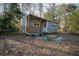 Cozy outbuilding with a charming porch, set among trees and natural landscaping at 2042 Highway 402, Moncks Corner, SC 29461