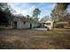 Back of the home with patio, lush lawn and manicured landscaping at 2042 Highway 402, Moncks Corner, SC 29461