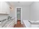Bright bathroom features a marble countertop, white cabinetry, and a bathtub at 208 Langham Ct, Moncks Corner, SC 29461