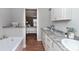 Bright bathroom features a marble countertop, dual sinks, a tub, and an ensuite doorway to the bedroom at 208 Langham Ct, Moncks Corner, SC 29461