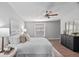 Comfortable bedroom features wood floors, a ceiling fan, and a large window for plenty of light at 208 Langham Ct, Moncks Corner, SC 29461