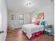 A bedroom featuring a comfortable bed, a window with blinds, and colorful decor for a welcoming atmosphere at 208 Langham Ct, Moncks Corner, SC 29461