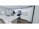 Bright kitchen features white cabinets, modern appliances, and center island with sink and marble countertops at 208 Langham Ct, Moncks Corner, SC 29461