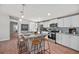 Modern kitchen with white cabinets, stainless steel appliances, island with bar stool seating, and stylish pendant lighting at 208 Langham Ct, Moncks Corner, SC 29461