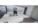 Kitchen features stainless steel appliances, white cabinets, and marble countertops with center island sink at 208 Langham Ct, Moncks Corner, SC 29461
