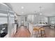 Bright kitchen showcases stainless steel appliances, a center island with barstools, and open layout into the living area at 208 Langham Ct, Moncks Corner, SC 29461