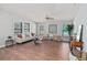 Spacious living room features hardwood floors, modern furniture, and plenty of natural light from the windows at 208 Langham Ct, Moncks Corner, SC 29461