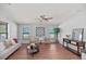 Bright living room featuring comfortable seating, a decorative rug, a ceiling fan and natural light from the windows at 208 Langham Ct, Moncks Corner, SC 29461