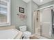 Bathroom featuring toilet, separate shower, and soaking tub under a window at 2136 Baldwin Park Dr, Mount Pleasant, SC 29466