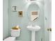Charming half bathroom featuring an oval mirror, pedestal sink, and framed wall decor at 2136 Baldwin Park Dr, Mount Pleasant, SC 29466