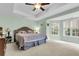 Spacious bedroom with tray ceiling, ceiling fan, carpet, and a large window allowing ample natural light at 2136 Baldwin Park Dr, Mount Pleasant, SC 29466