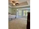 A spacious bedroom features a cozy queen bed, ceiling fan, and a large window for natural light at 2136 Baldwin Park Dr, Mount Pleasant, SC 29466
