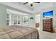 Bright bedroom with a ceiling fan, carpet, bay windows, and a TV mounted above a wooden dresser at 2136 Baldwin Park Dr, Mount Pleasant, SC 29466