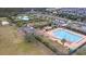Aerial shot showcasing a large community pool with a lap lane, kiddie pool, clubhouse, playground, and ample green space at 2136 Baldwin Park Dr, Mount Pleasant, SC 29466